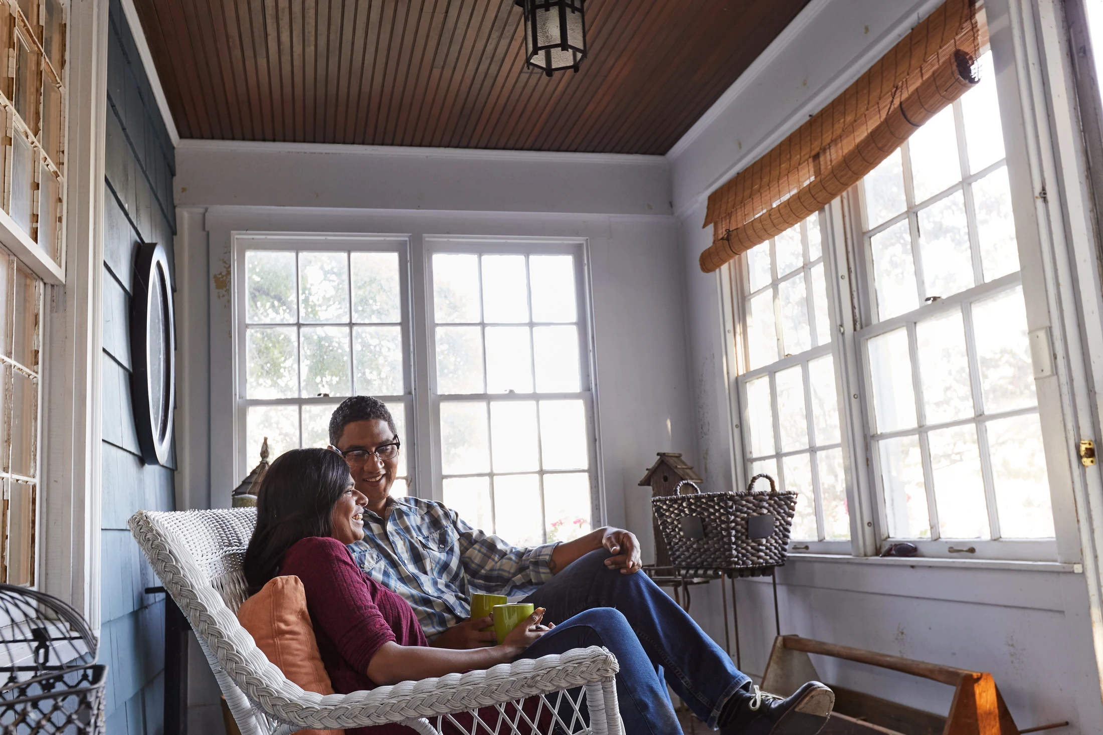 A man and woman sitting on a porch.