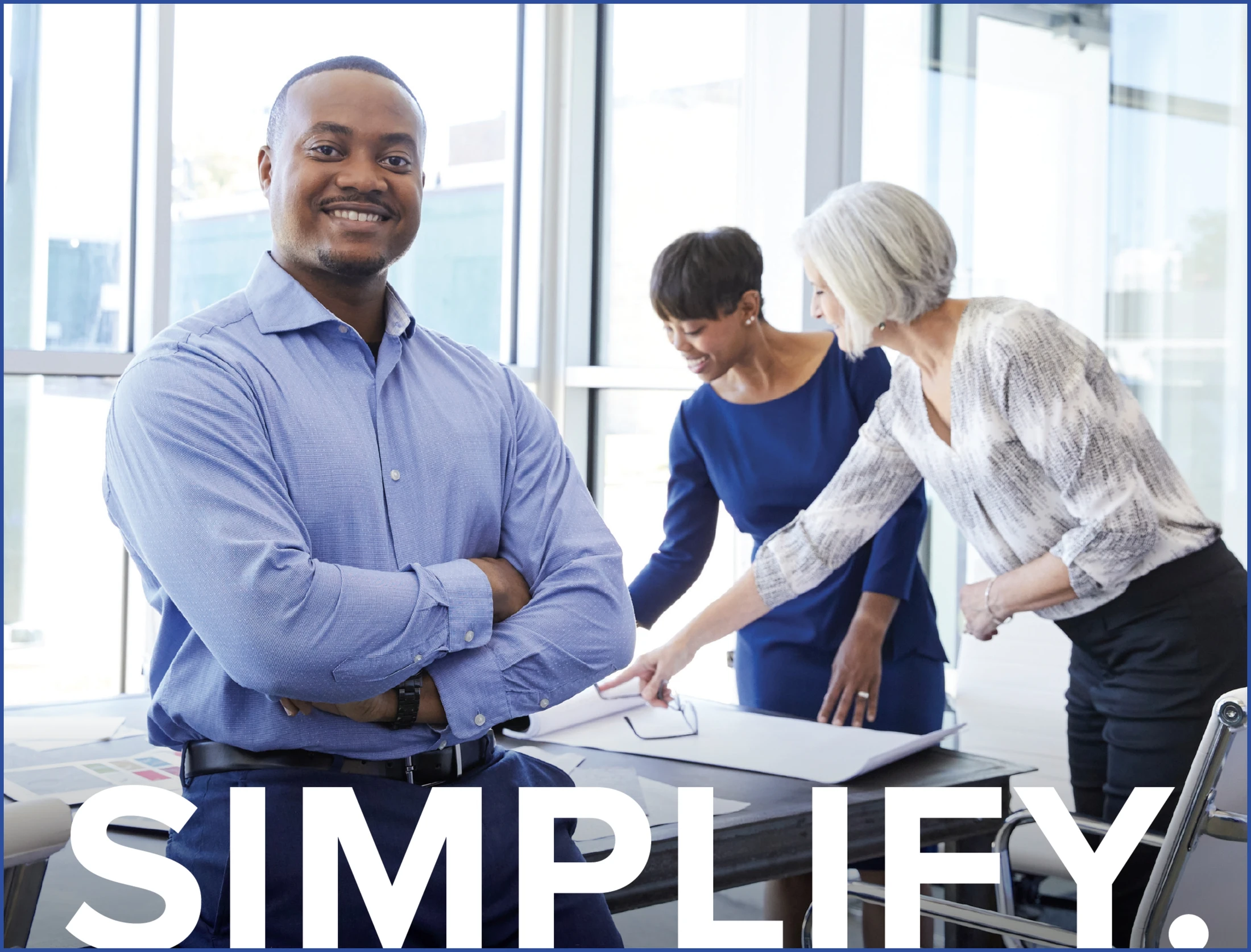 A group of people standing in an office with the words simplify.