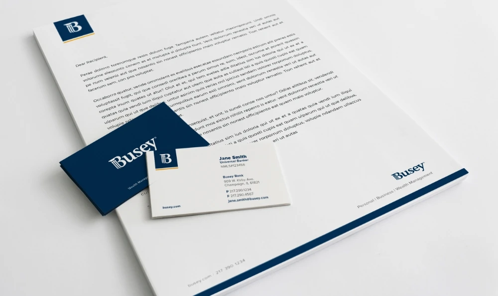 A business card and letterhead on a white background.