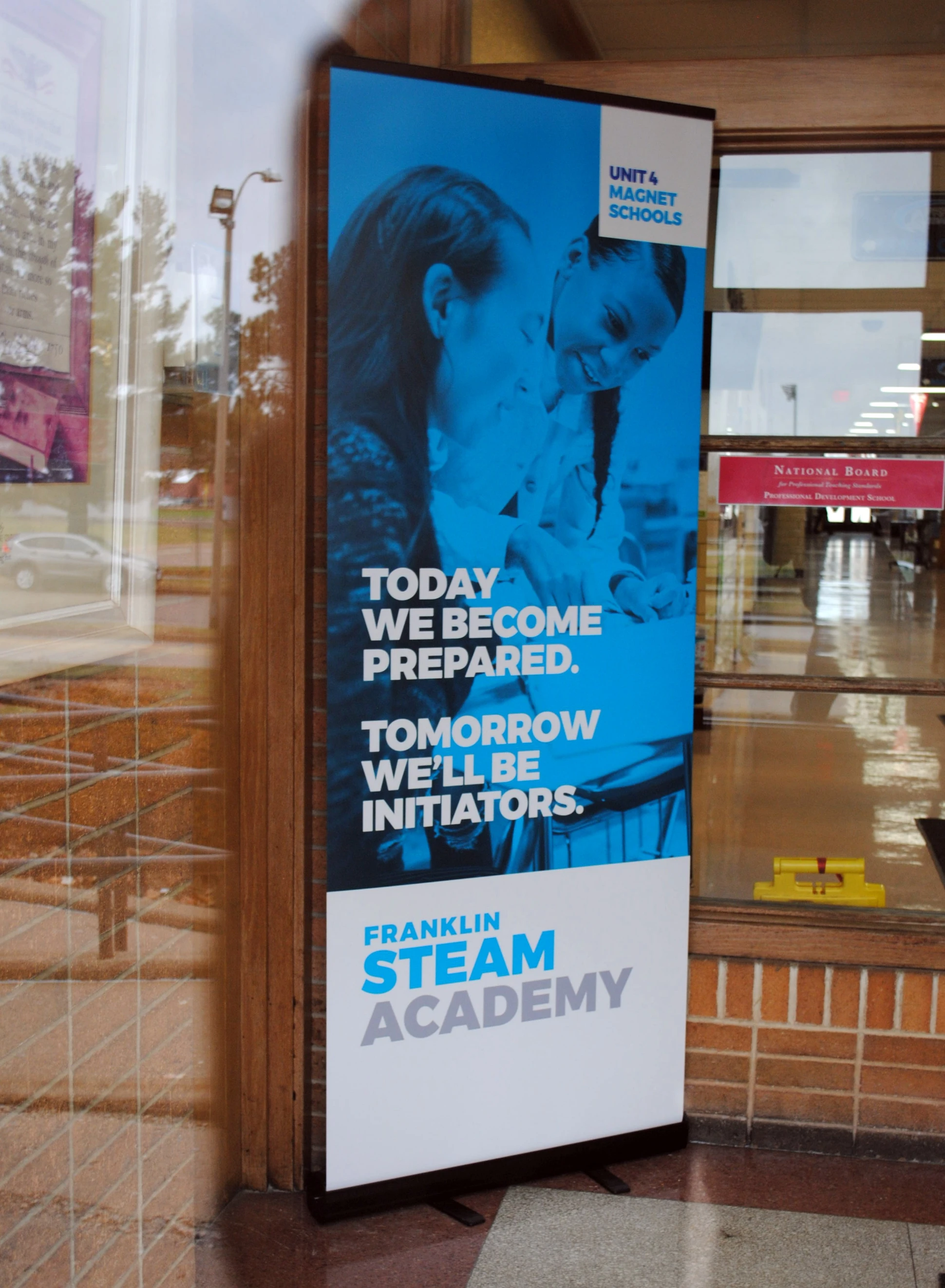 A banner advertising the stam academy in front of a building.
