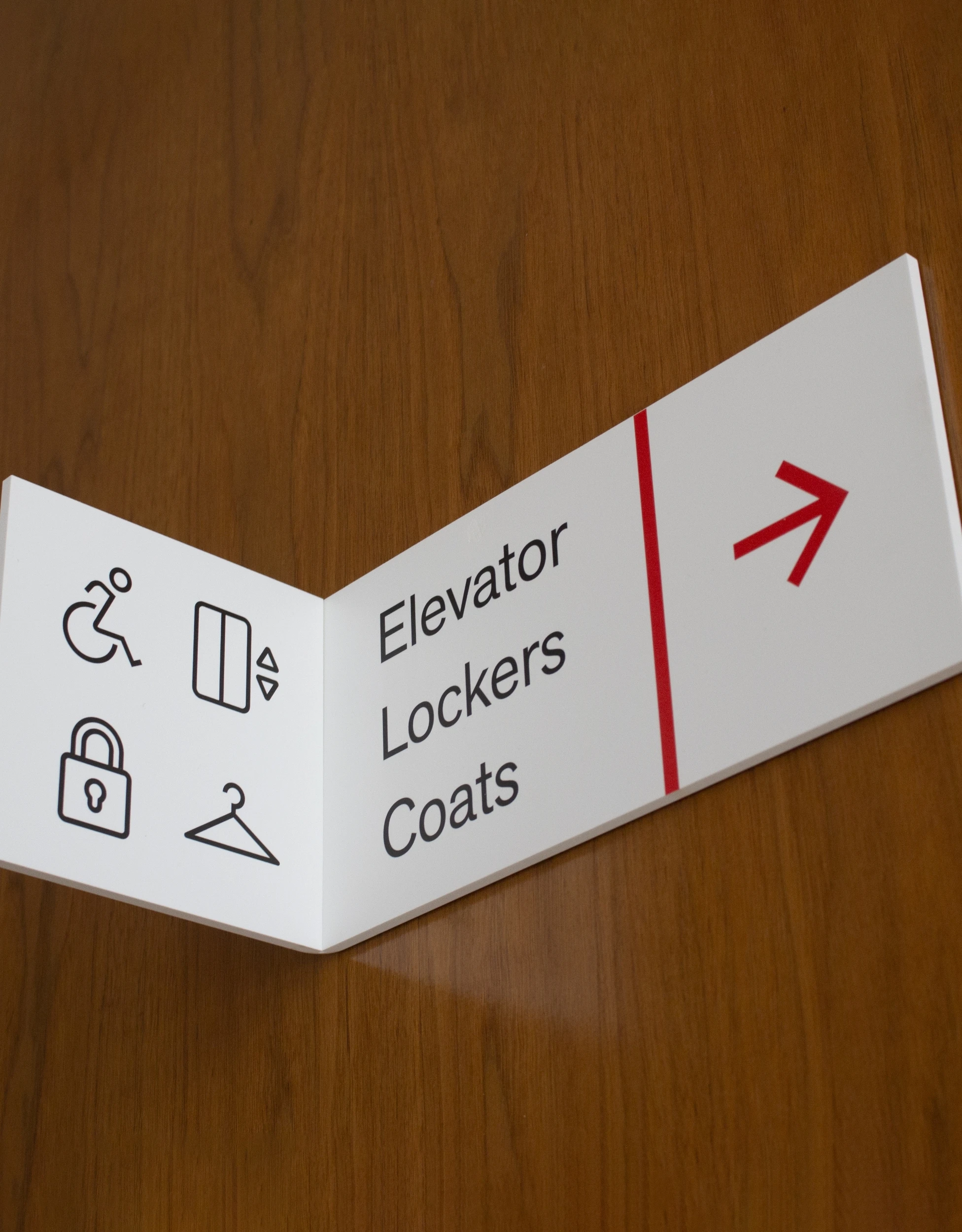 A sign that says elevator lockers coats.