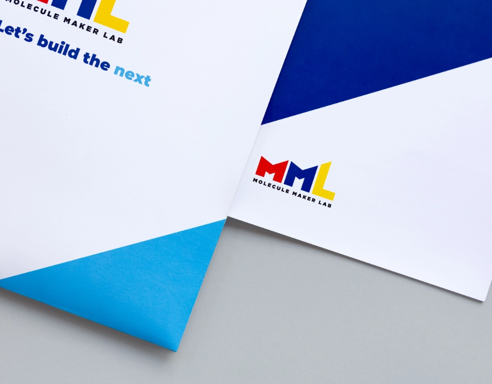 An image of a folder and a small booklet with MML branding on it.