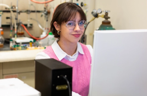 A woman using a computer in a lab setting.