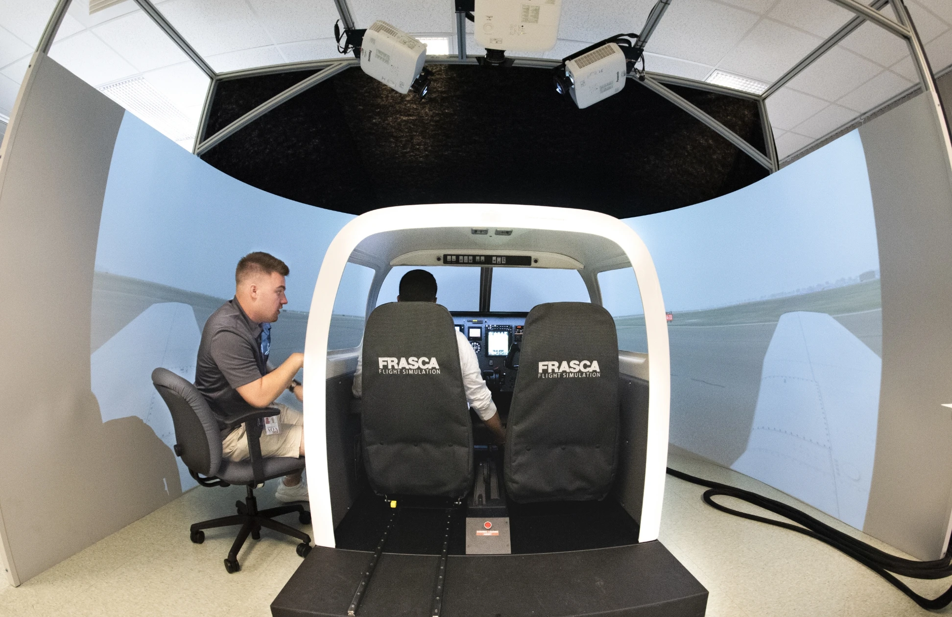 A photo of a flight simulation booth.