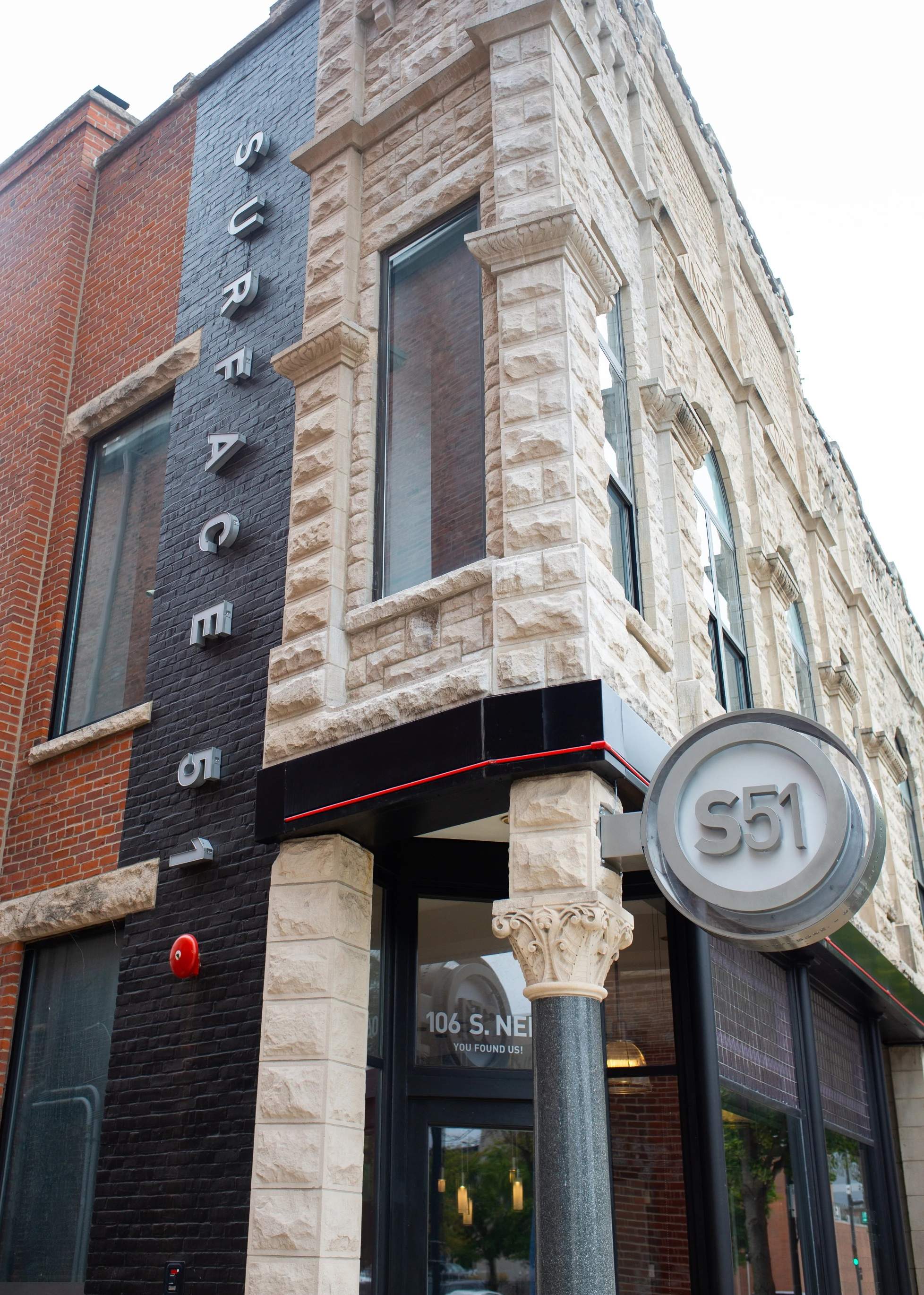 A brick building with a sign on it.