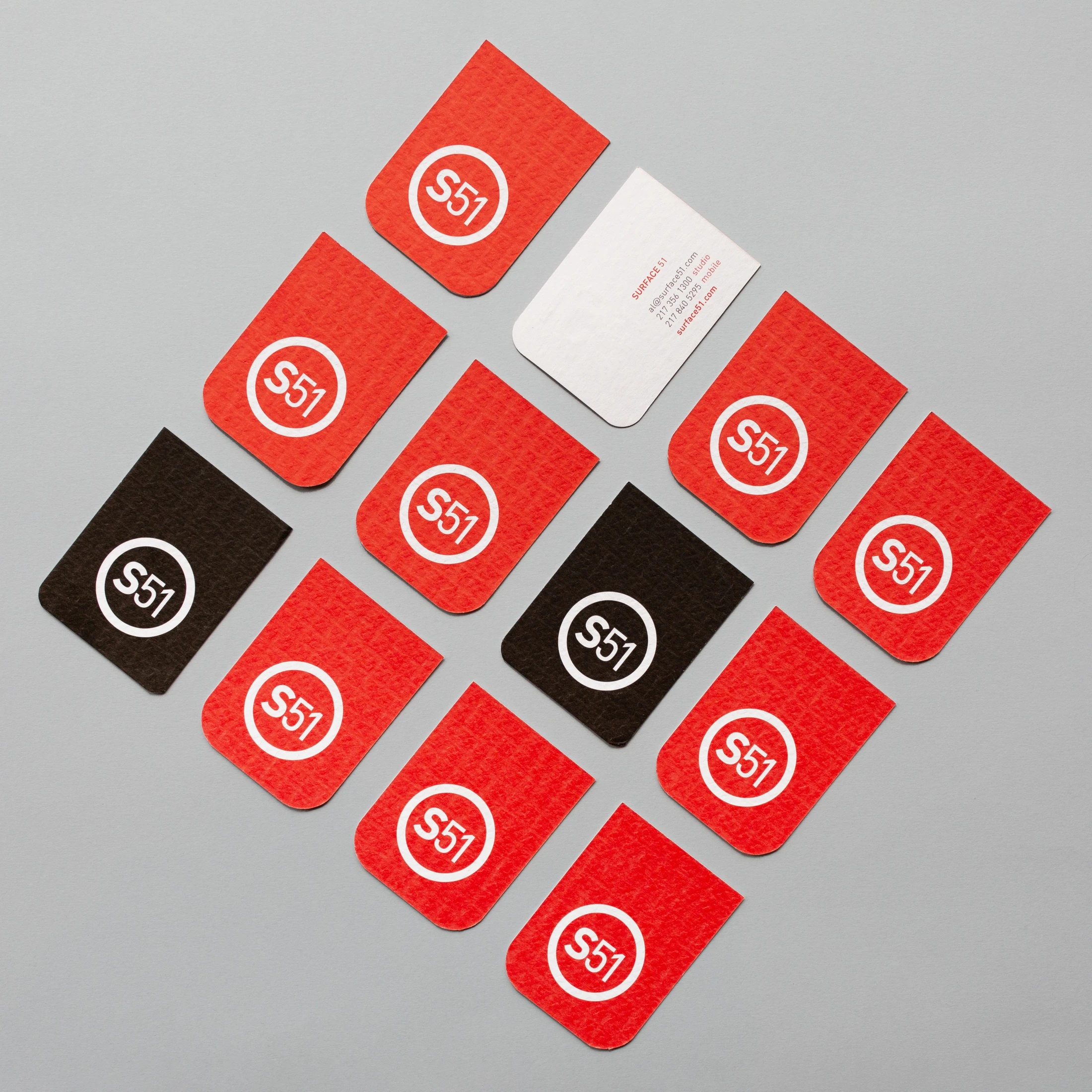 A set of business cards with red and black circles.