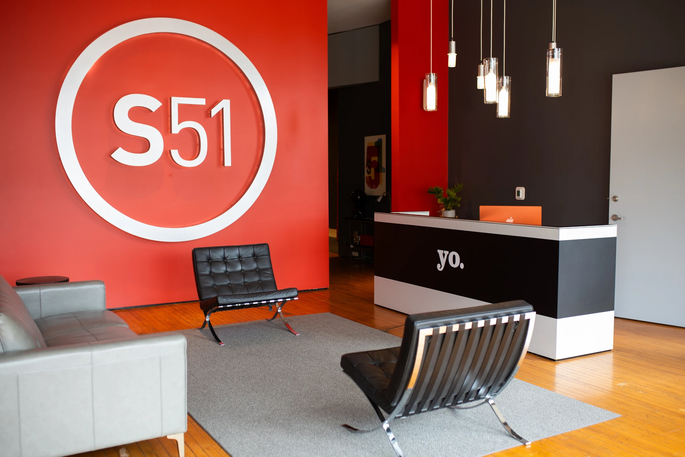 A reception area with a red and black wall.