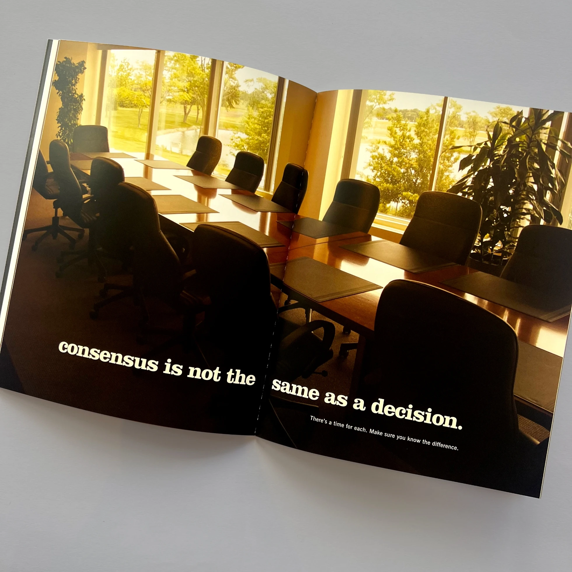 An open book with a picture of a conference room.