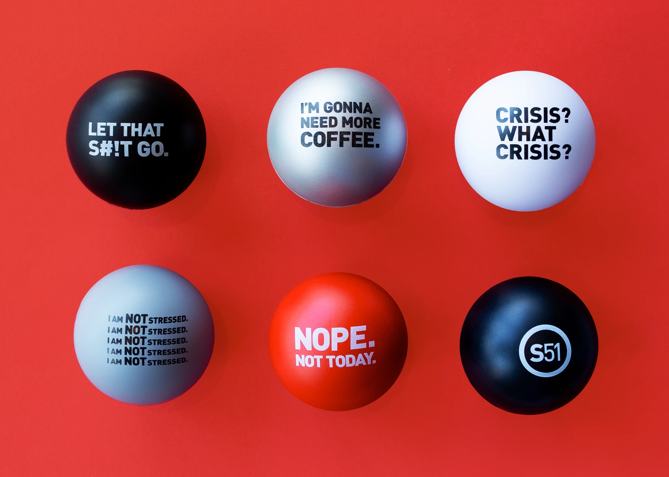 A group of black and red eggs with different words on them.