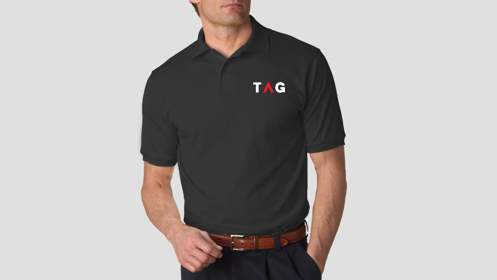 A man wearing a black polo shirt with the tg logo on it.