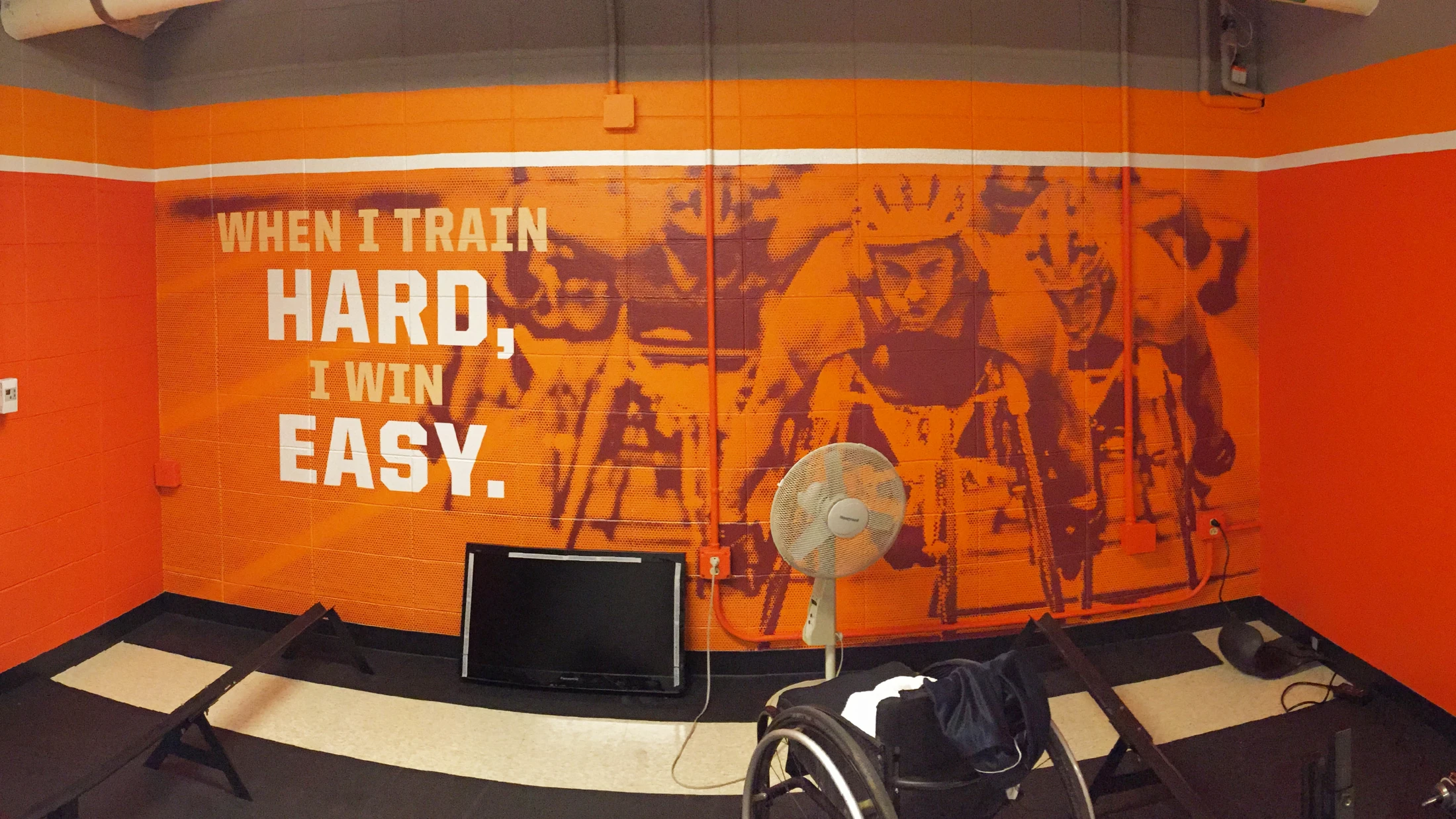 A room with a wall mural that says when it's hard, it's easy.